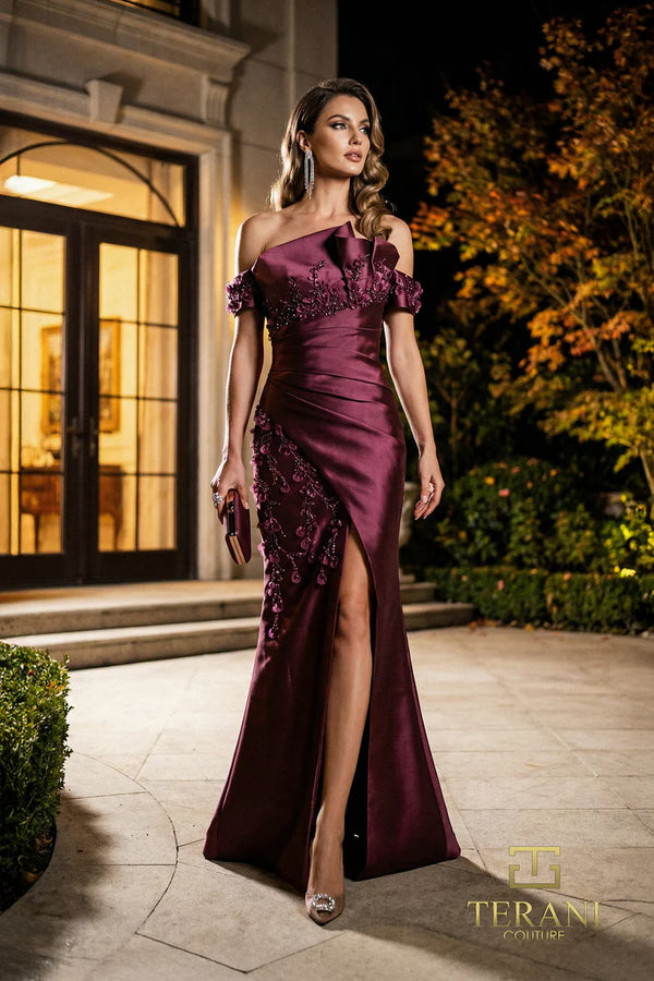 Model wearing Terani Couture 262M7254 off-the-shoulder mermaid evening gown with cap sleeves, floral appliqués, draped bodice, front slit, and sweeping train.  The model is wearing the color wine.  Front View.