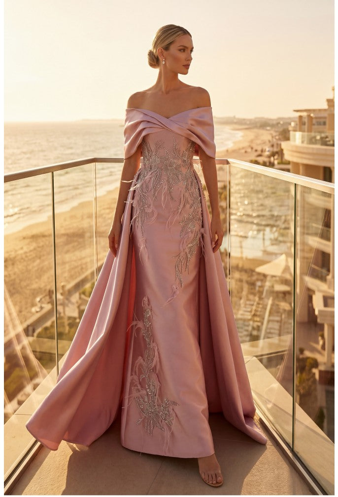 Model wearing Terani Couture 262M7271 off-the-shoulder gown with embroidered appliqués, detachable overskirt, and floor-length silhouette.