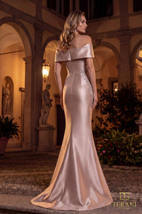 Woman in a elegant off-shoulder gown standing in an outdoor setting with classical architecture.