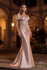 Woman in a elegant evening gown standing in an outdoor setting with classical architecture.