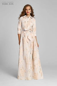 Model wearing Teri Jon 207015 floral shirt gown with a collared neckline, sash belt, three-quarter sleeves, and full A-line skirt.