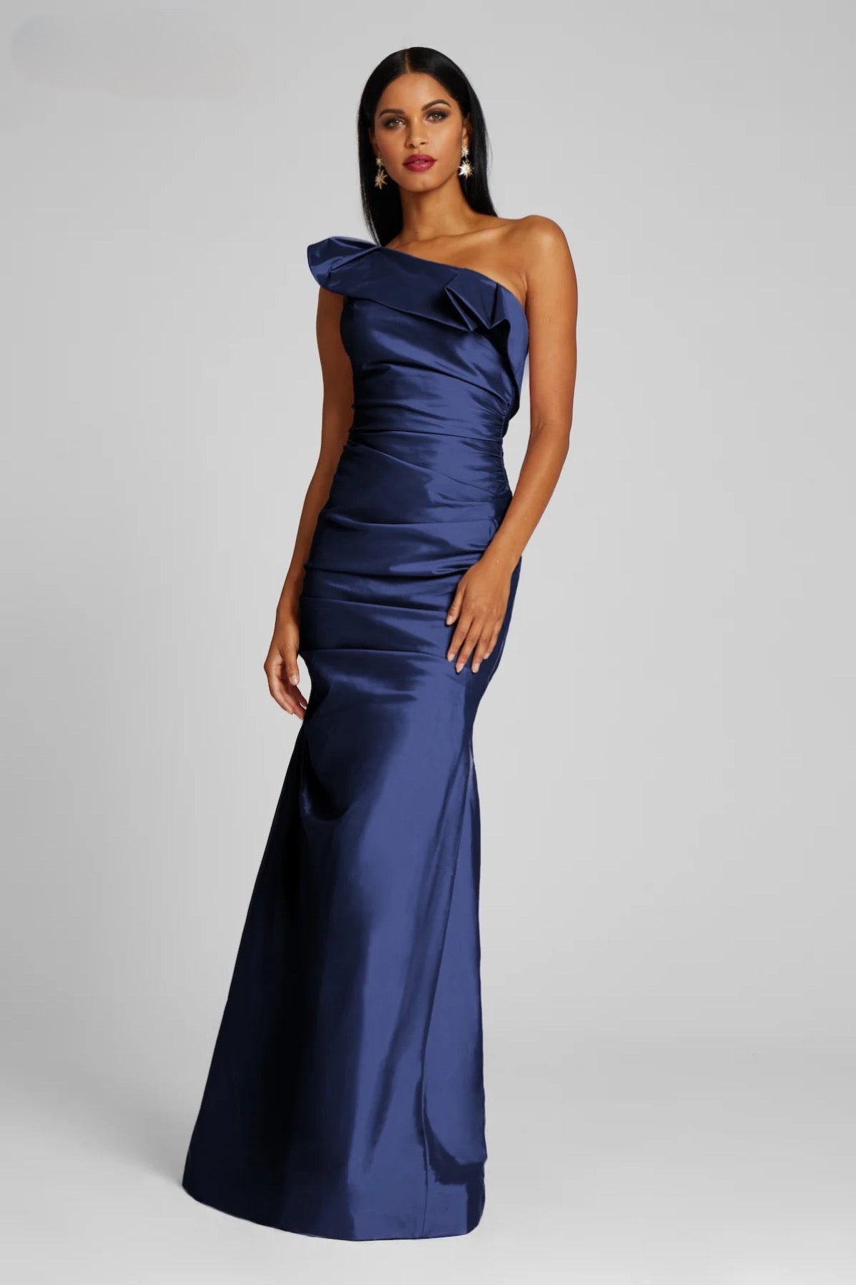 A stunning floor-length taffeta gown by Teri Jon, featuring a one-shoulder design with draped detailing, perfect for mother of the bride or groom occasions, black tie parties, and galas. Available at Madeline's Boutique in Toronto and Boca Raton.