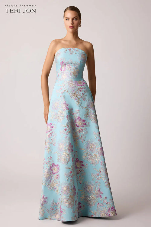Teri Jon 259019 strapless gown with a scalloped neckline, metallic floral design, fitted bodice, and full A-line skirt.