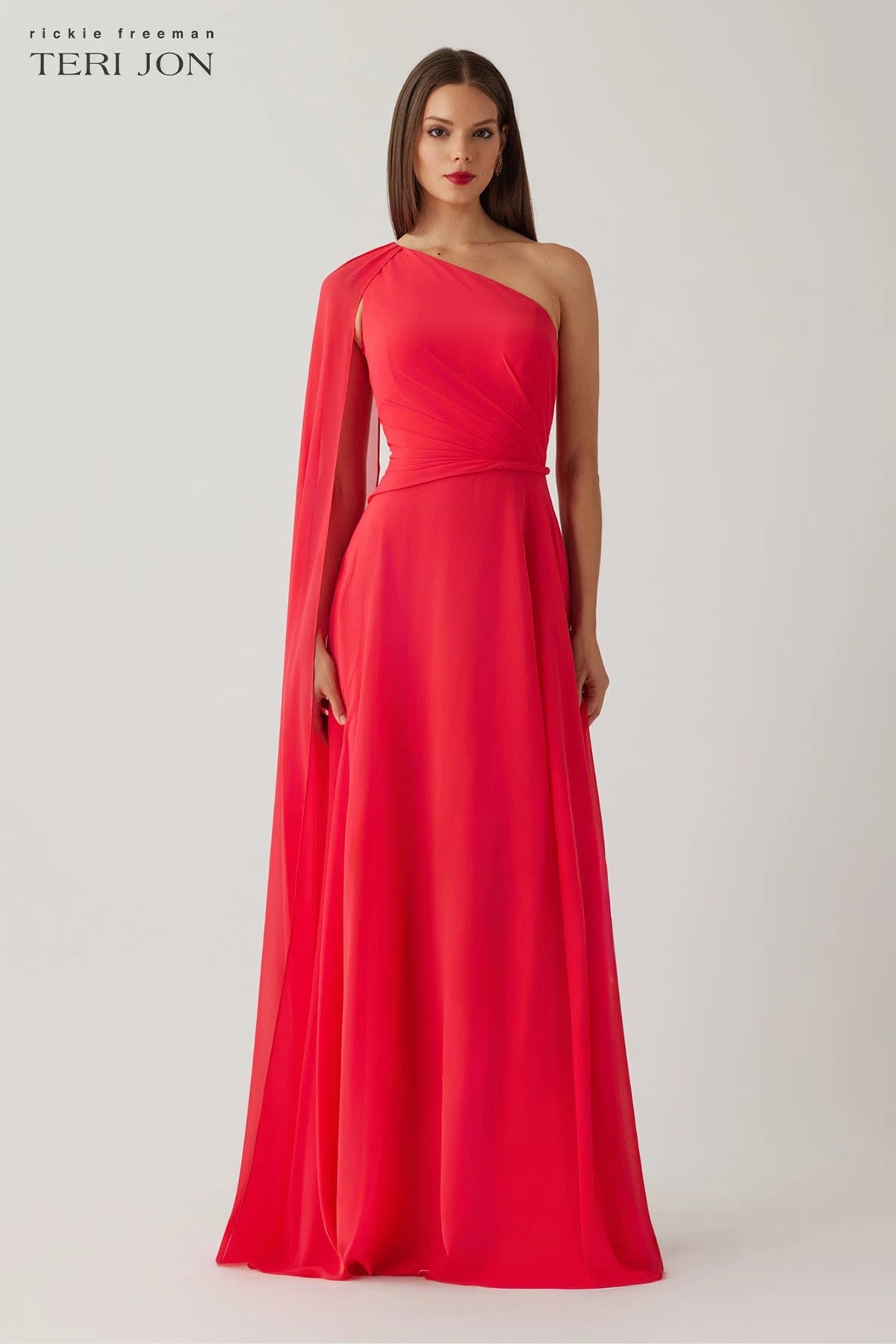 Model wearing Teri Jon 266020 one-shoulder evening gown with cape sleeve detail.