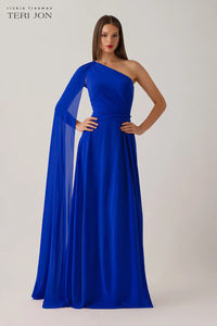 Model wearing Teri Jon 266020 one-shoulder evening gown with cape sleeve detail.