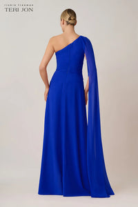 Model wearing Teri Jon 266020 one-shoulder evening gown with cape sleeve detail.