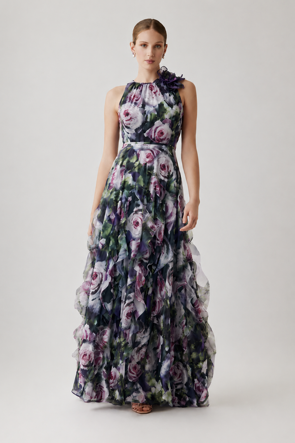Model wearing Teri Jon 267030 floral halter gown featuring a floral shoulder detail and layered ruffle skirt.