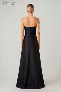 A woman shown from the back wearing a strapless black floor-length gown against a light gray studio background. The brand text 'richie freeman TERI JON' appears in the upper left corner.