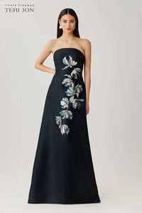Black strapless evening gown with floral embroidery on a white background, featuring the brand 'Teri Jon'.