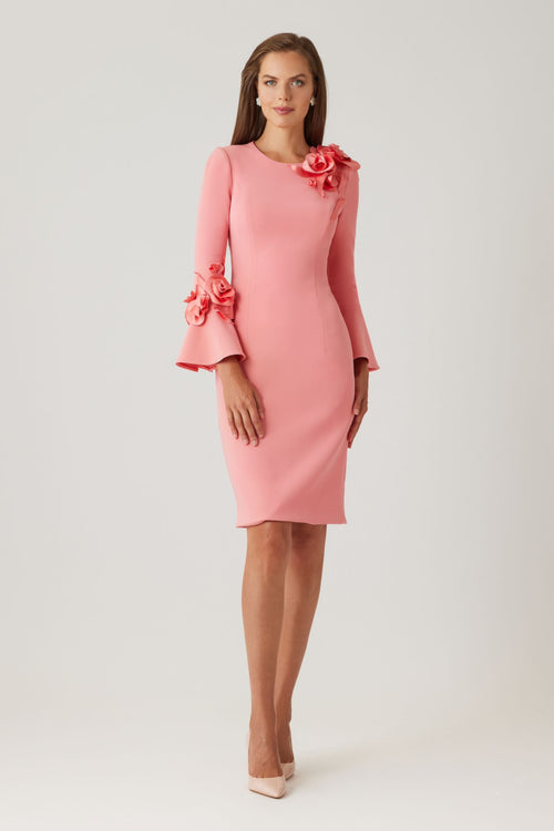 Model wearing Teri Jon 269212 fitted dress with floral appliqués and flare cuffs.