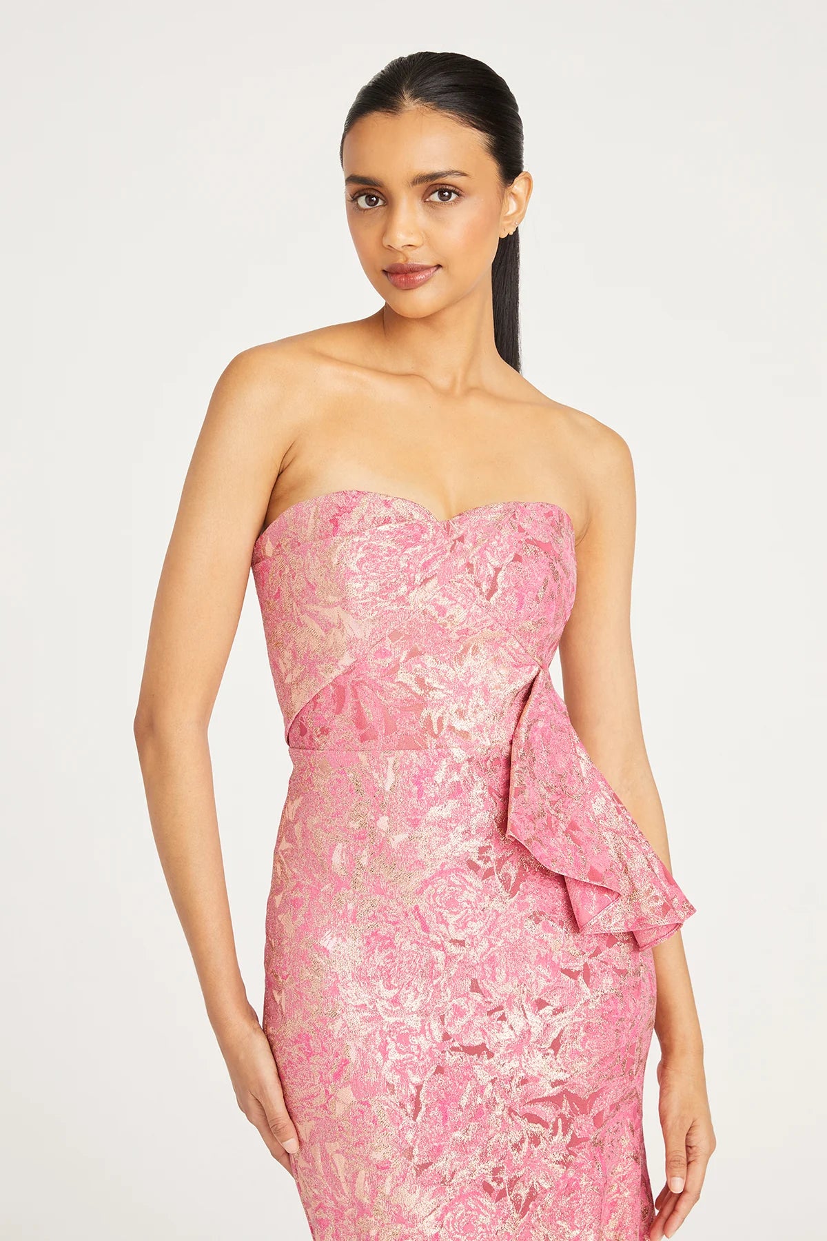 Shop the exquisite charm of Madeline's Boutique with this stunning Theia strapless dress. Style number 8819846 in camellia color. Embrace the fitted, fit-and-flare silhouette crafted from high-stretch jacquard fabric. Perfect for any occasion. Visit our Toronto and Boca Raton locations for a personalized shopping experience.