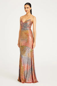 Stunning Brynn Cowl Neck Sequin Gown in Daydream color by Theia, available at Madeline's. Perfect for special occasions, this floor-length dress features spaghetti straps, a cowl neck, and a fitted silhouette. Made with printed sequins and offering a slight stretch, it exudes elegance and charm. Shop now at Madeline's in Toronto and Boca Raton.