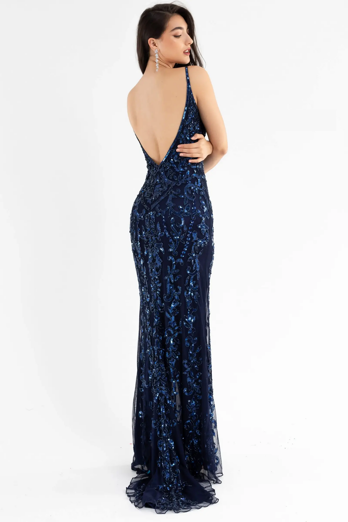 Shop this stunning Primavera dress in Midnight sold by Madeline's Boutique in Toronto and Boca Raton. This sleeveless gown features a fitted silhouette with a plunging neckline and intricate beading detail throughout, perfect for making a bold statement at any high school prom. Purchase now and shine bright like a star on your special night!