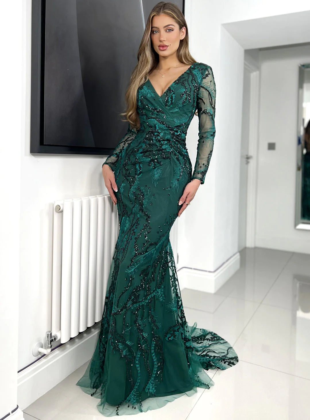 Jadore JX6092 Navy, Dusty Mauve, and Forrest Green Beaded Lace Dress with V-Neckline, Sheer Sleeves, and Ruching. Padded Bust, Small Train, and Center Back Zip. Sold by Madeline's Boutique in Toronto, Canada and Boca Raton, Florida.