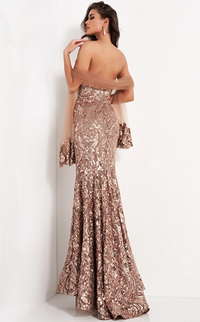 Make a statement in this stunning copper sequin embellished evening dress by Jovani. Featuring a fitted mermaid style with a train and sweetheart neckline, this strapless lace gown is perfect for formal occasions. Sold by Madeline's Boutique.