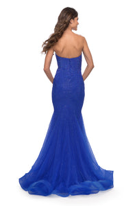 The La Femme 31285 in royal blue is a radiant fully rhinestone embellished prom dress in with a strapless sweetheart neckline.  It is perfect for a glamorous evening. Sold by Madeline's Boutique.