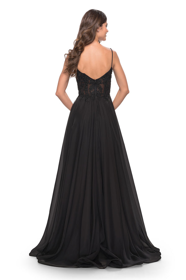 Steal the show with La Femme style 30639 evening gown. A-line silhouette, floor-length chiffon skirt, and a sheer bodice adorned with floral lace and rhinestone detailing. Perfect for prom night. Available at Madeline's Boutique, Toronto & Boca Raton.