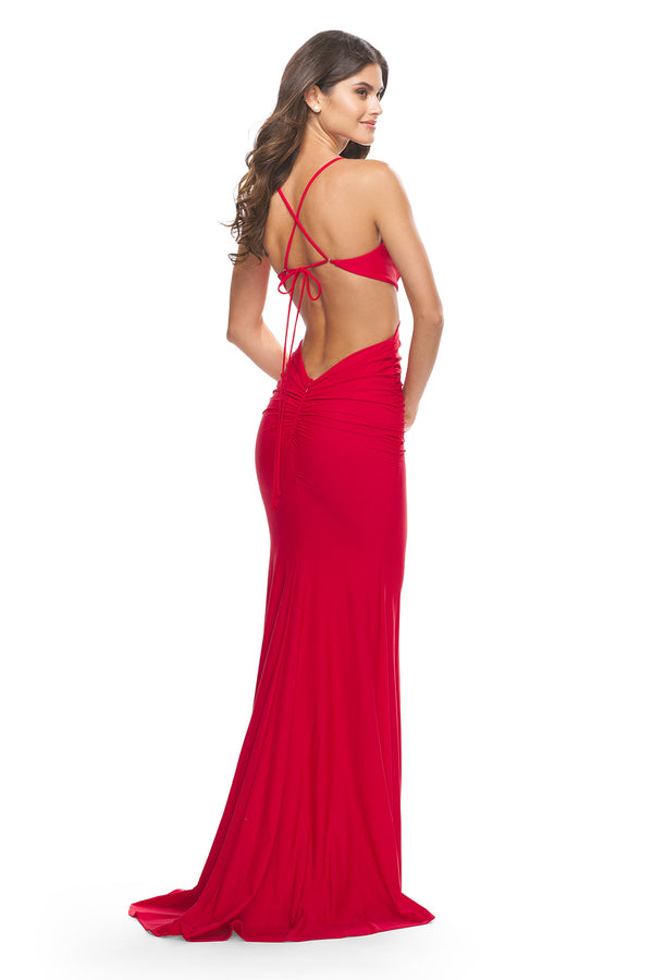 La Femme 31228 - A chic jersey prom dress with side cutouts, a deep V neckline, and an open back with a single adjustable tie, perfect for a modern and alluring look at prom. The model is wearing the dress in the color red.