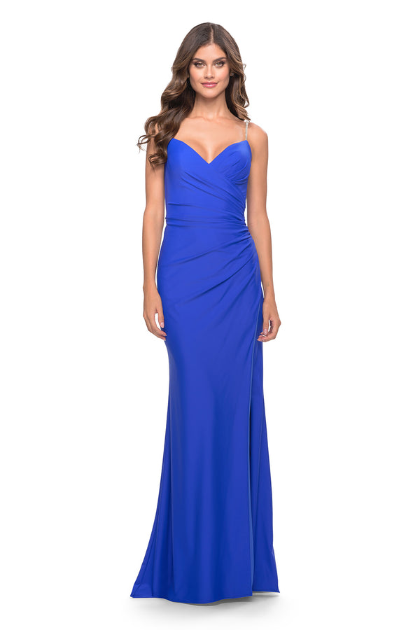 Shop the stunning La Femme 31107 dress at Madeline's boutiques in Toronto and Boca Raton. Jewel-adorned spaghetti straps, ruched bodice, and high slit make this long jersey dress a flattering choice for any occasion.